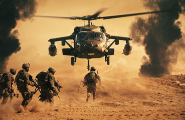 Five soldiers run toward a military helicopter hovering above sandy terrain, with dark smoke rising in the background, suggesting an active combat or rescue scene.