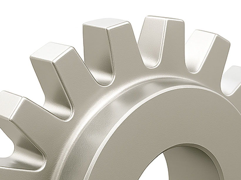 Close-up of a metallic gear showing several teeth and part of the central hole, set against a plain white background.